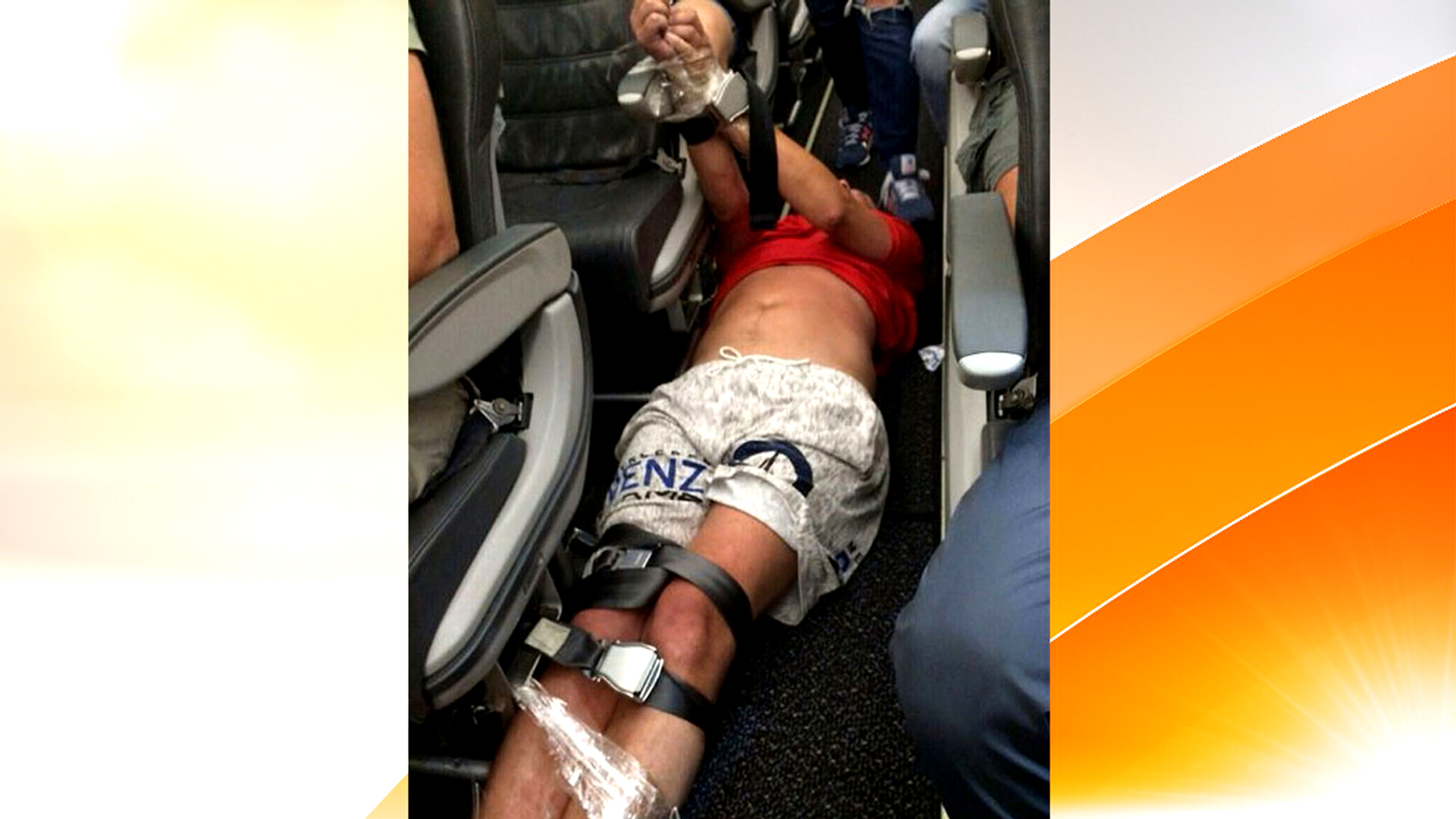 Watch: Unruly plane passenger tackled, tied up with seat belts.