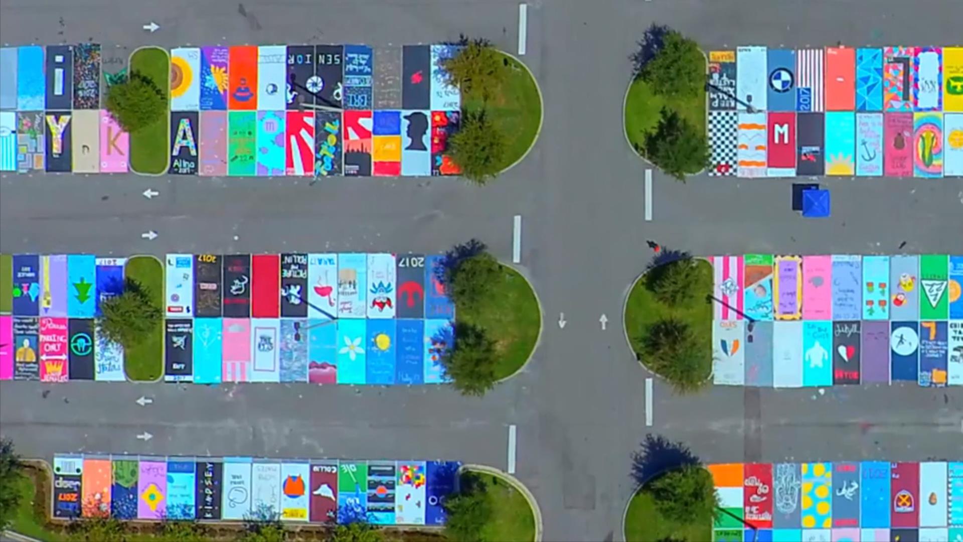 High school seniors paint parking spaces into beautiful works of art