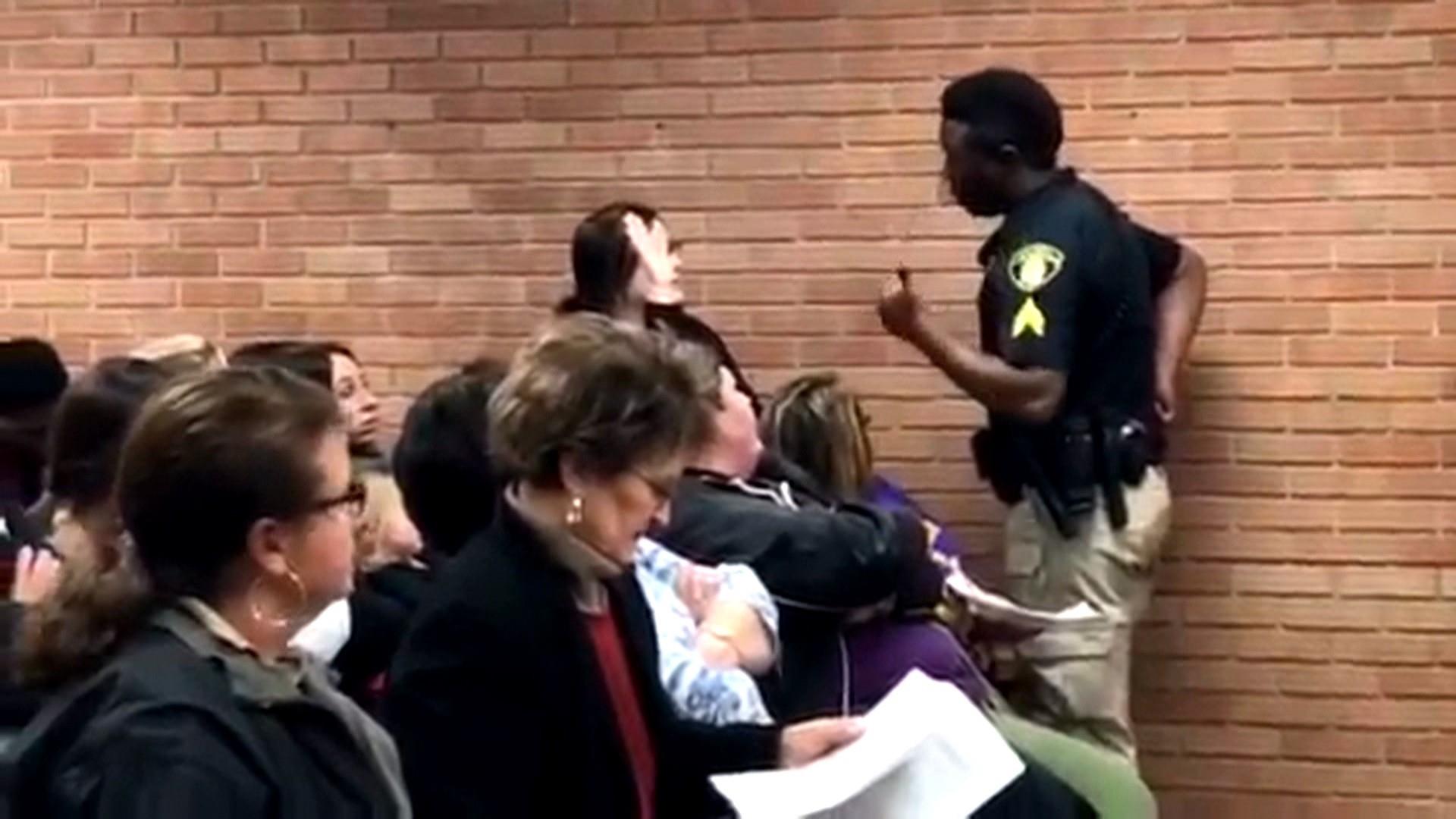 Teacher handcuffed after speaking out at meeting, caught on video.