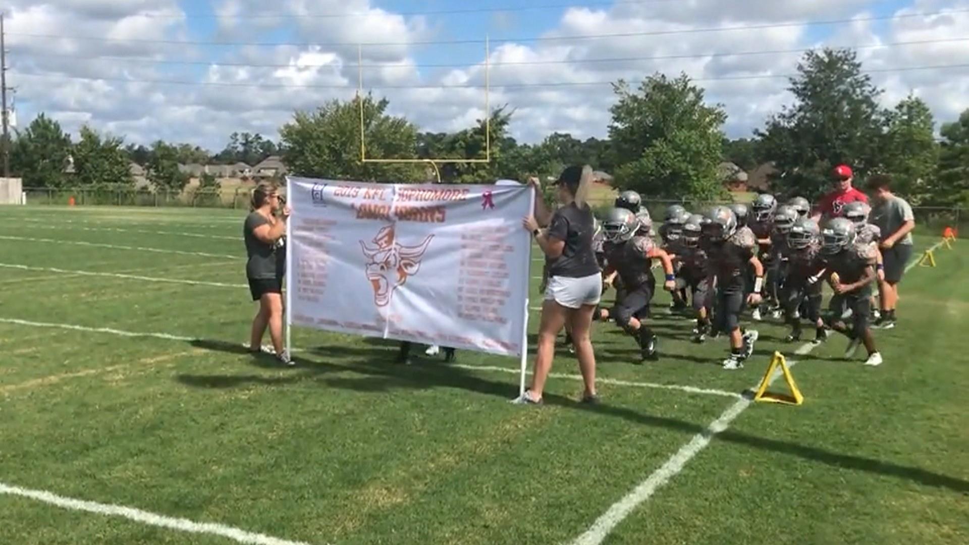 Football team 2025 running through banner