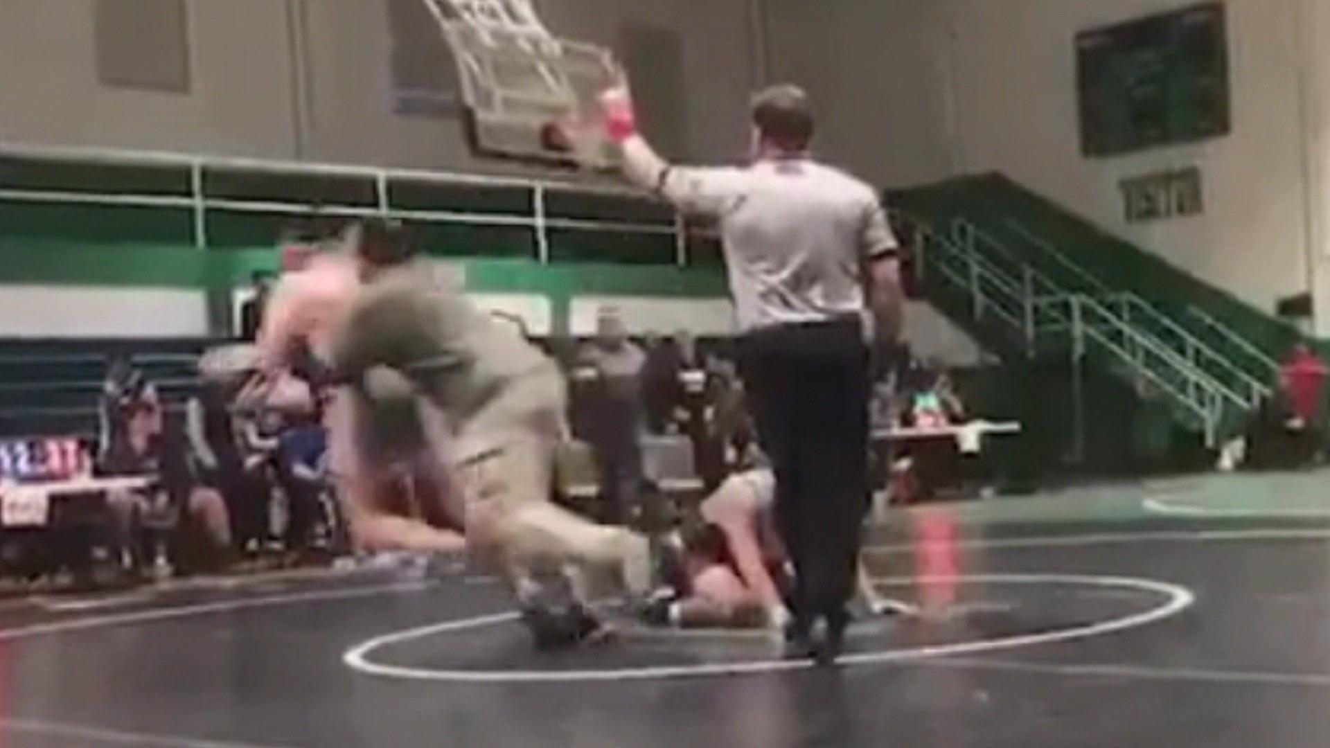 Dad tackles sons wrestling opponent, caught on video photo