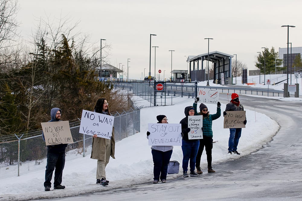 People protest outside airport.