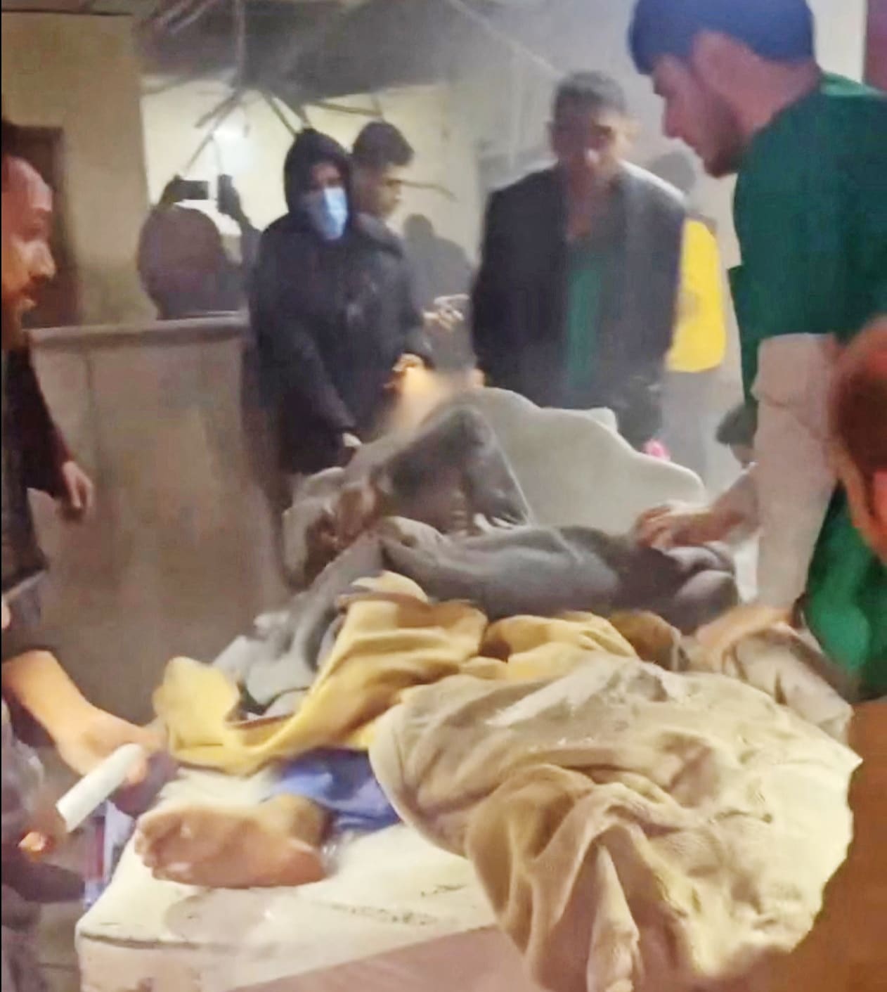 An injured person is attended to amid commotion at Nasser Hospital in Khan Younis