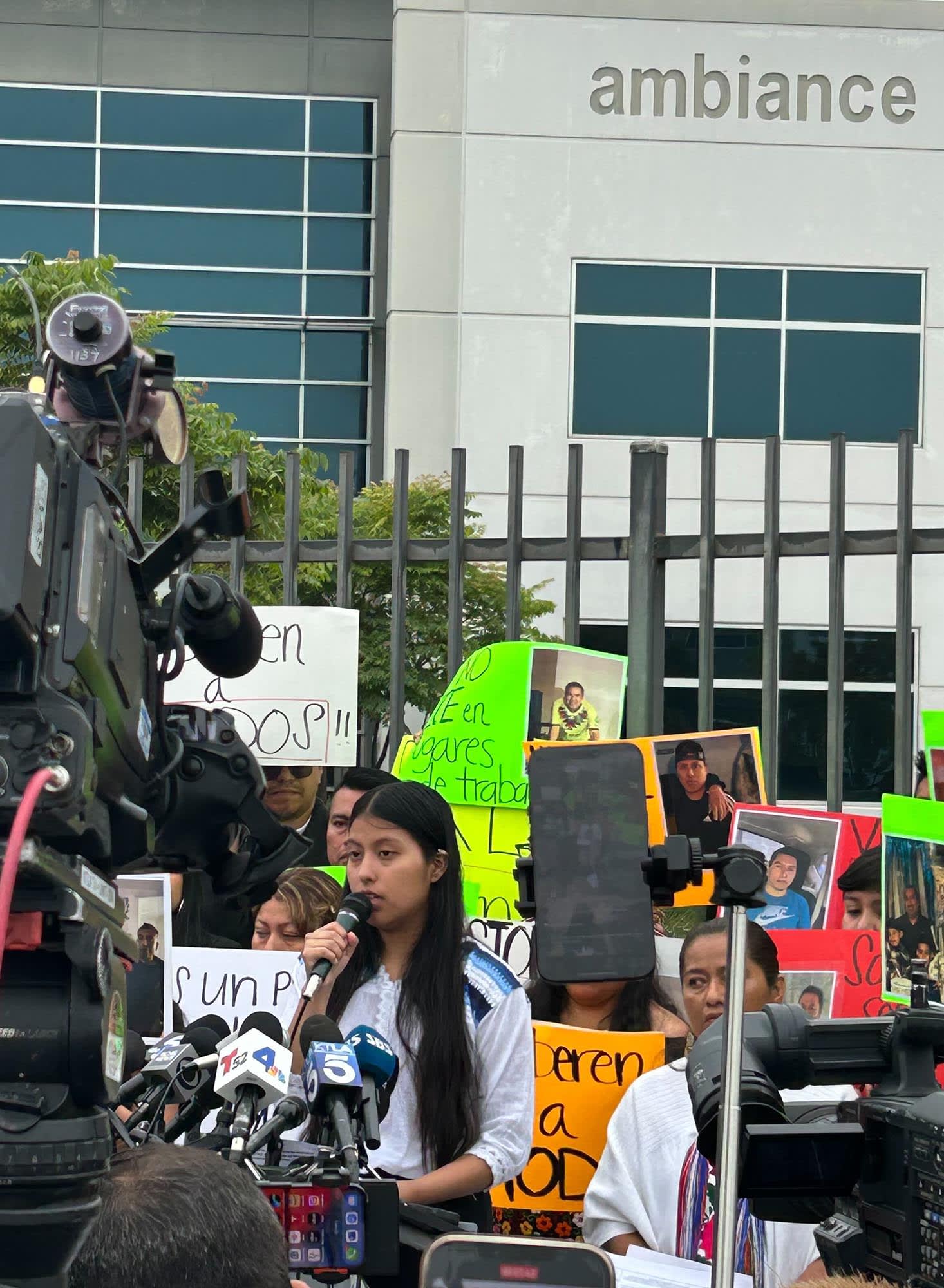 A woman speaks outside Ambiance Apparel in Los Angeles
