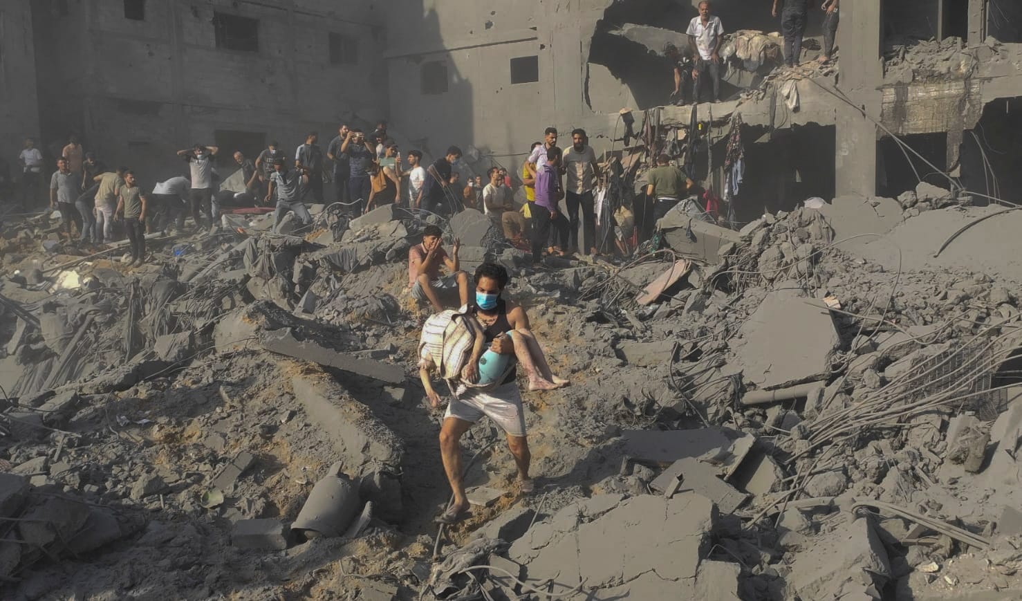 Palestinians search for casualties at the site of Israeli strikes on houses in Jabalia refugee camp