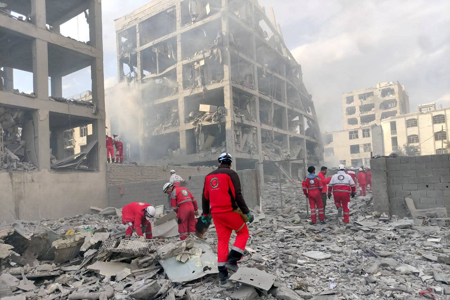 Rescue teams from the Iranian Red Crescent Society work at the site of a building damaged by an airstrike in Resalat Square, Tehran, on March 10, 2026.