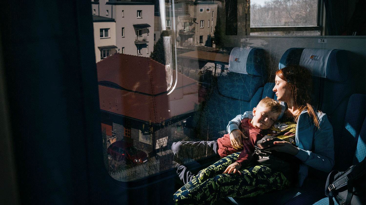 Images of Ukrainian refugee families traveling on a train from Poland to Berlin, Germany.
