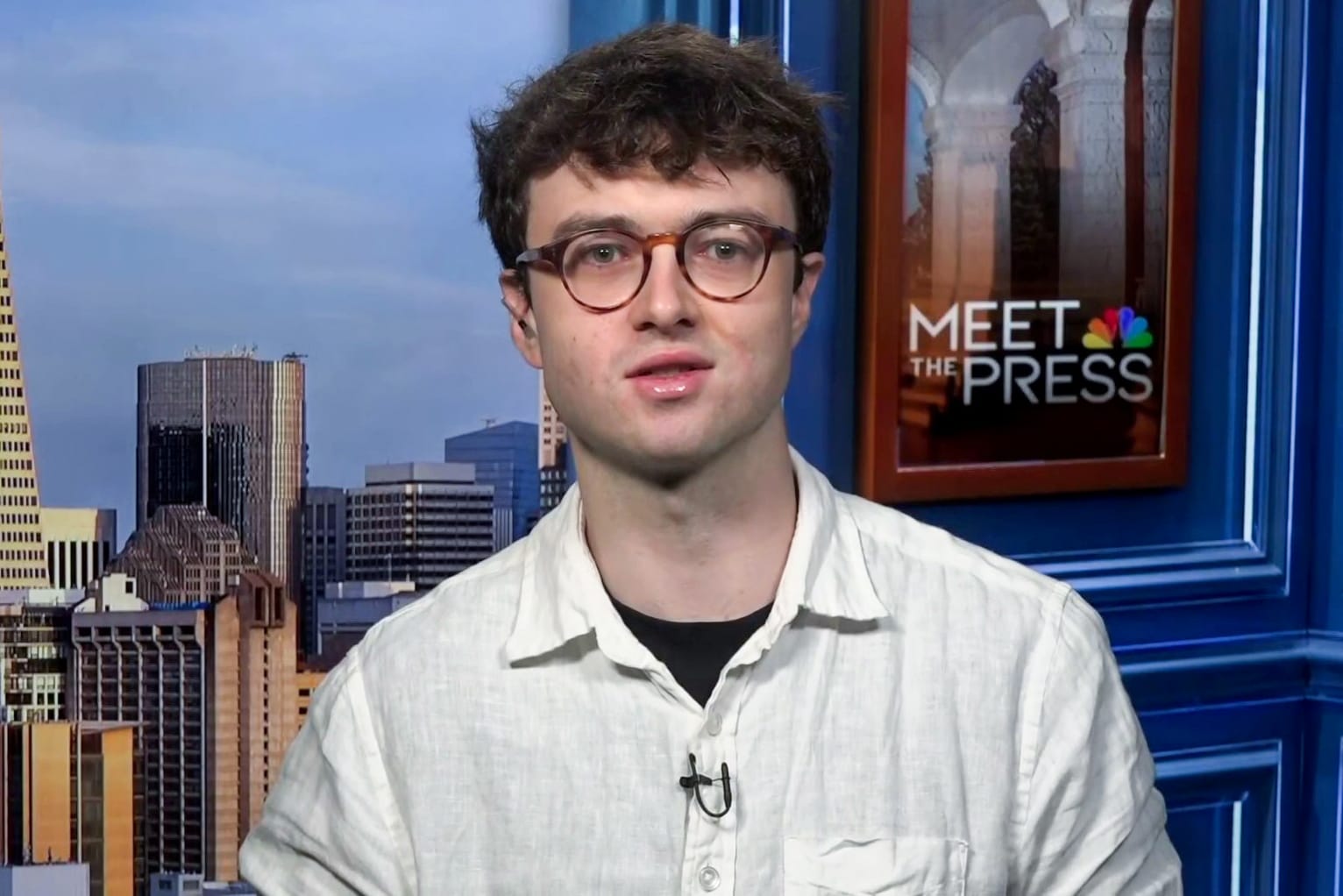 Jacob Coxon speaks while seated on the set of Meet the Press