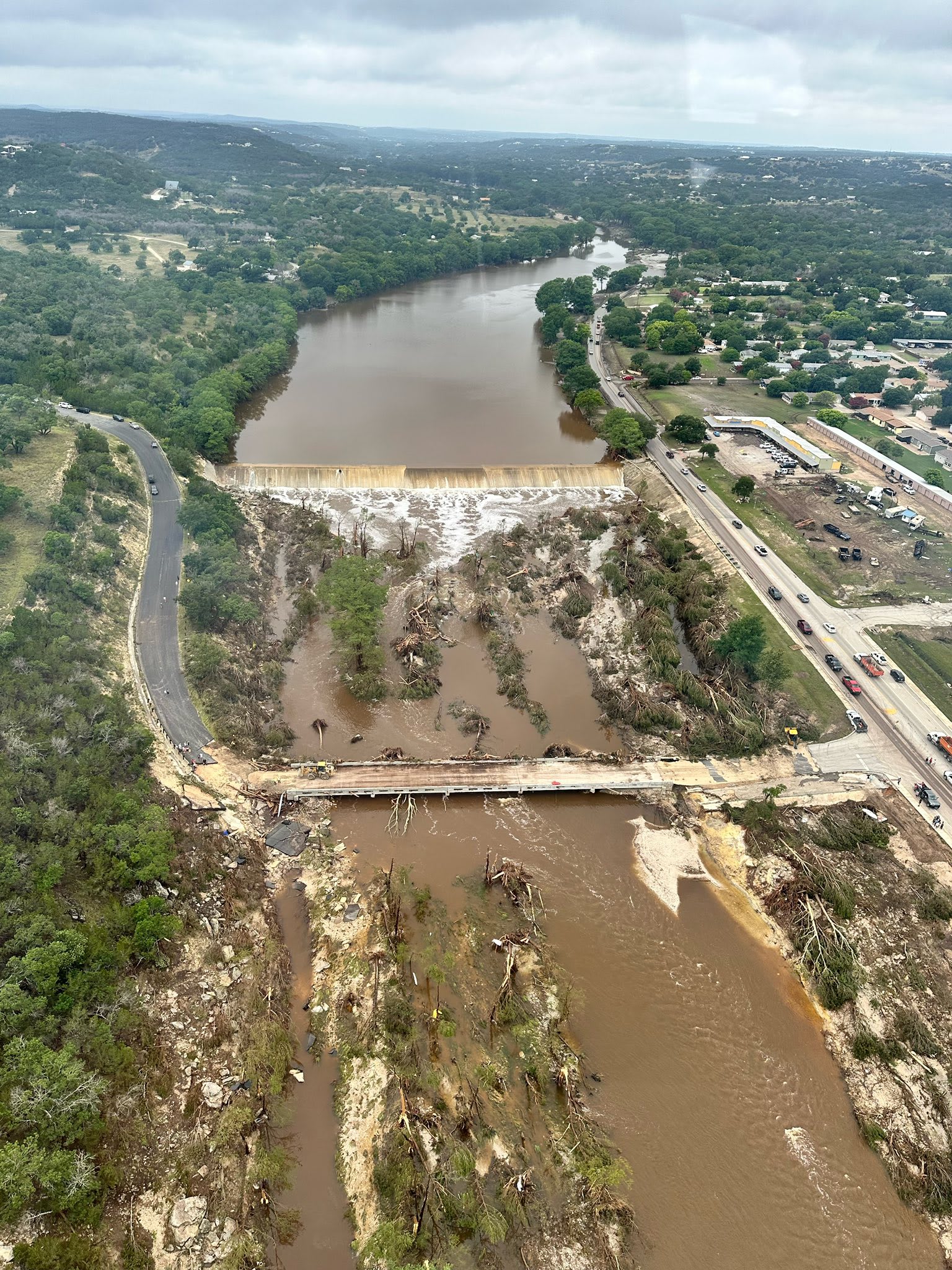 An aerial view of The Hunt Dam, flood damage can be seen on the surrounding land