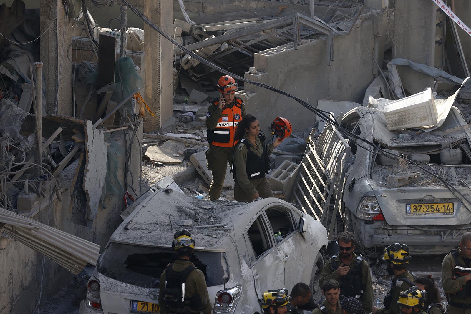 Israeli rescuers search through the rubble at the site of an Iranian missile strike in Bnei Brak on June 16, 2025.