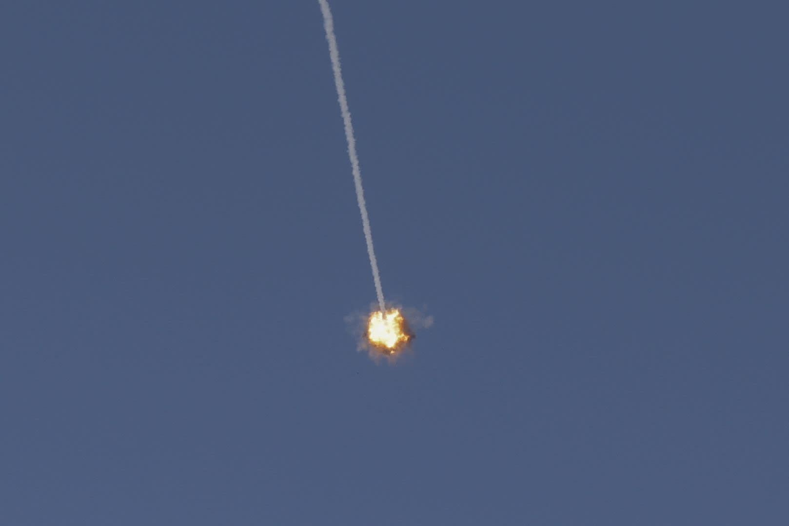 an Israeli Iron Dome missile streaking across the sky to intercept incoming projectiles