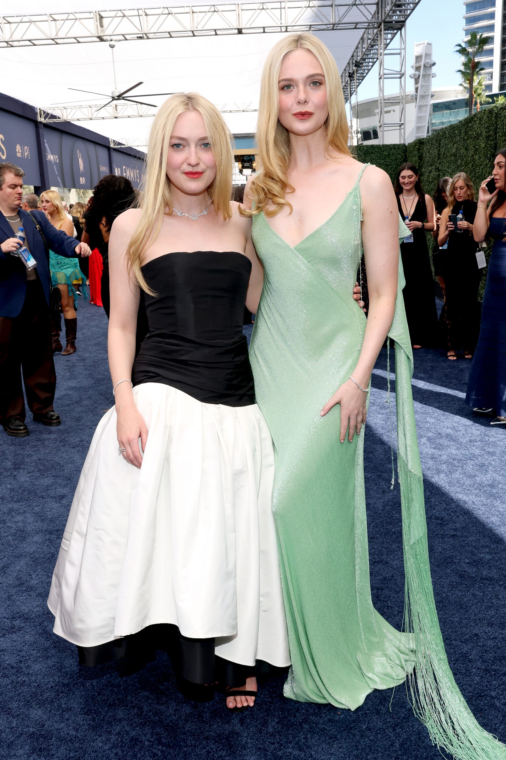 Dakota and Elle Fanning pose together.