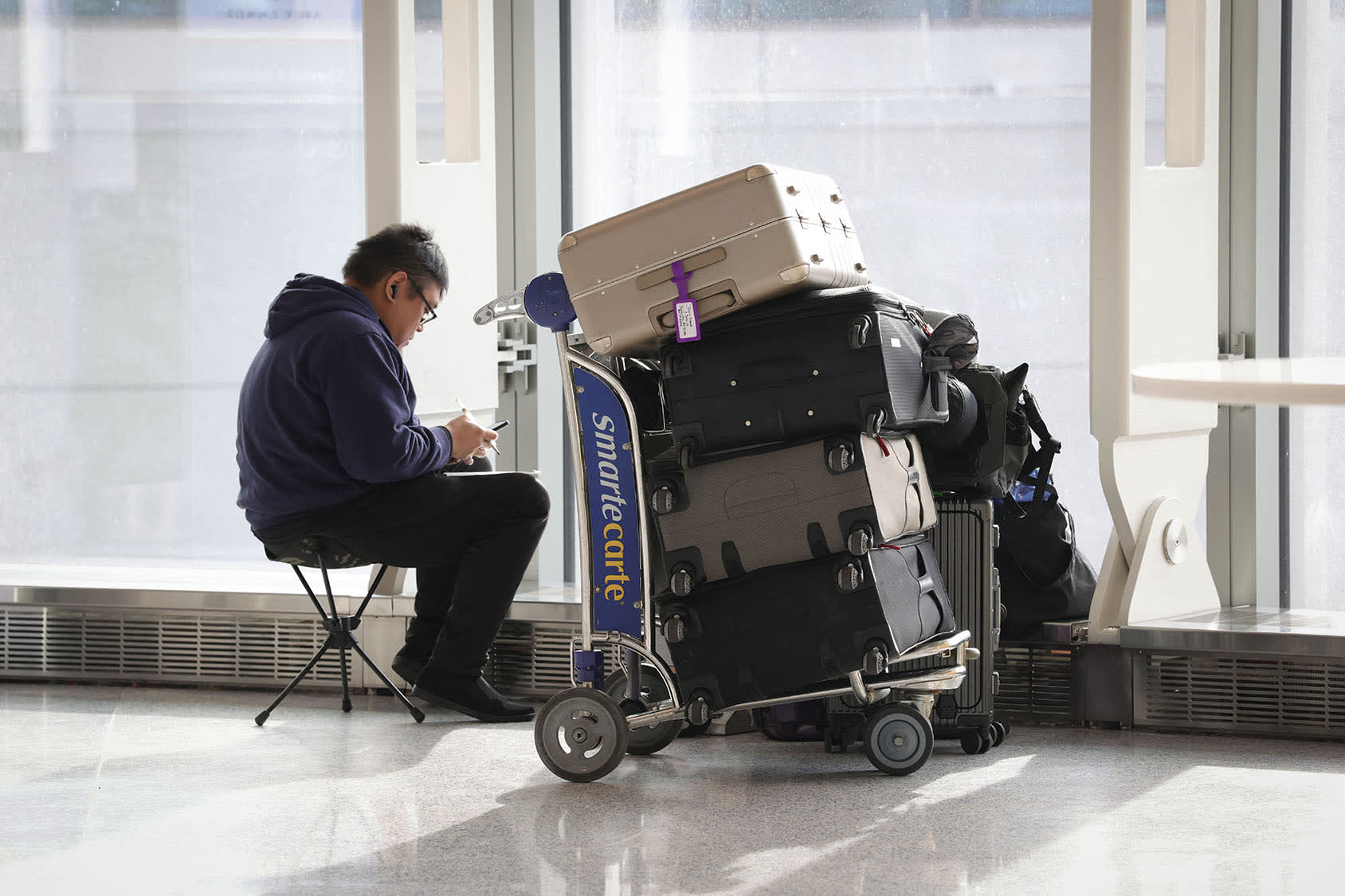 A traveler waits with his luggage at Newark Liberty International Airport in Newark, New Jersey, on Nov. 7, 2025. 