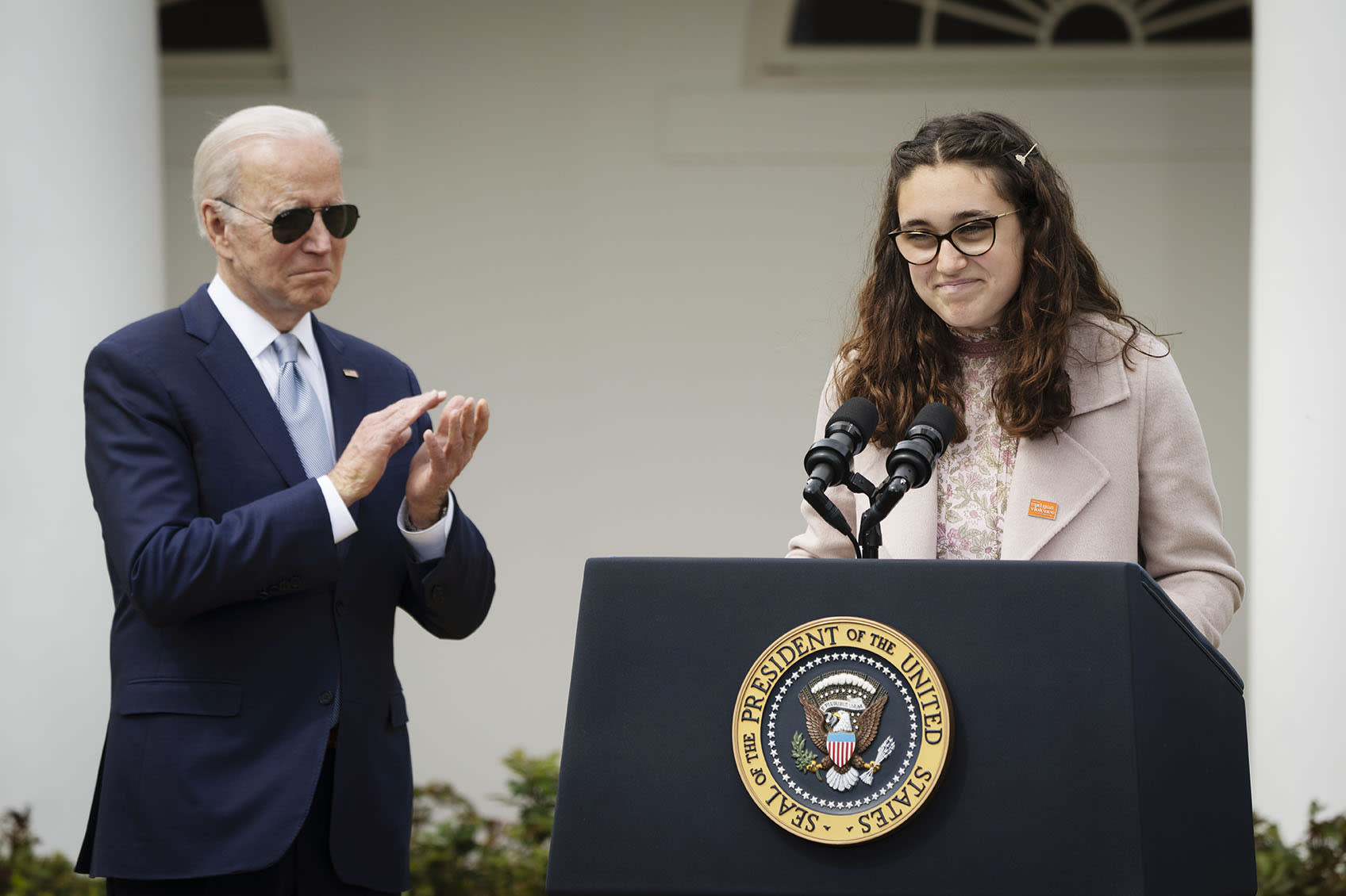 President Joe Biden applauds as Mia Tretta, speaks in the Rose Garden of the White House