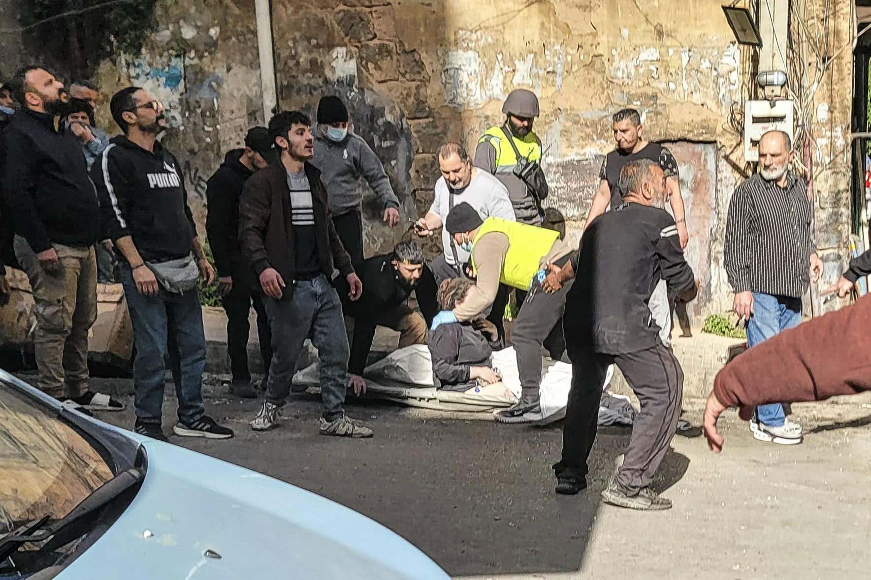 Paramedics treat a wounded person at the site where an apartment was struck by an Israeli airstrike in central Beirut on March 18, 2026.