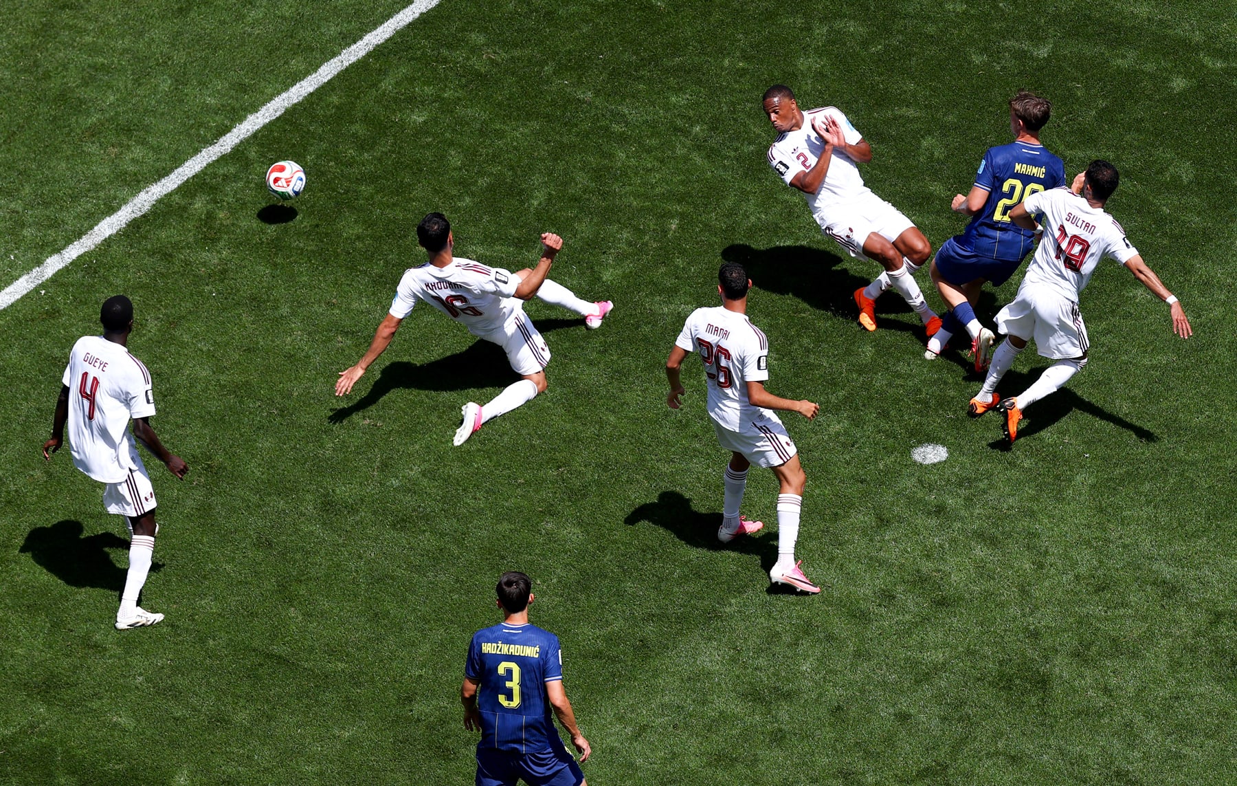 Ermin Mahmic of Bosnia and Herzegovina scores his team's third goal, surrounded by other players on the field, aerial view