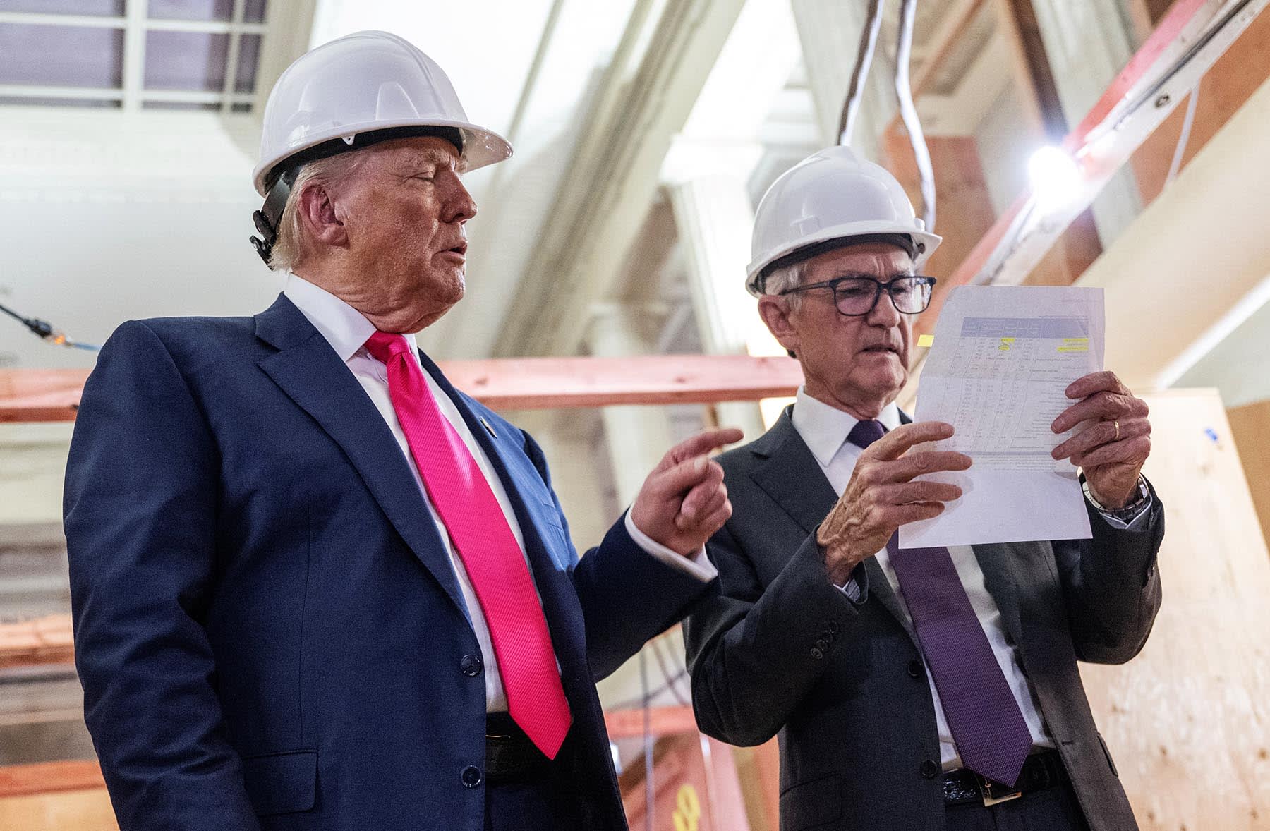 President Donald Trump points to a cost sheet as he speaks with Federal Reserve chair Jerome Powell at the Federal Reserve in Washington on July 24, 2025. 
