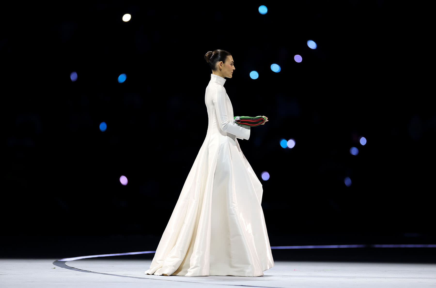 Vittoria Cerett carries the Italian flag.