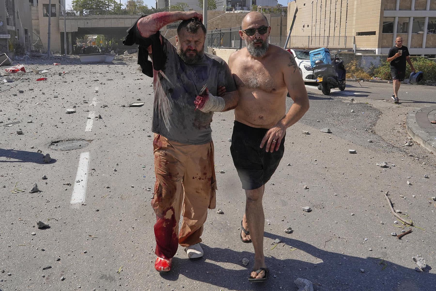 An injured man is evacuated from a site struck by an Iranian missile in Haifa, Israel, on Friday, June 20, 2025.