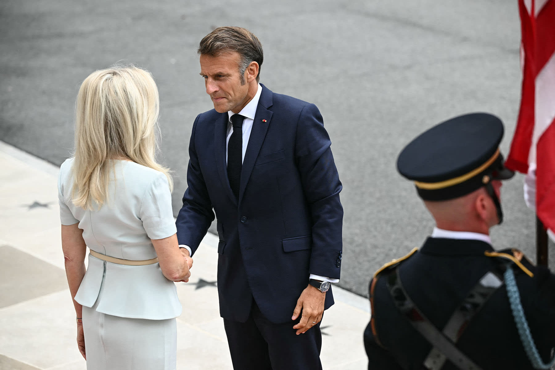 French President Emmanuel Macron is greeted by Chief of Protocol Monica Crowley at the White House