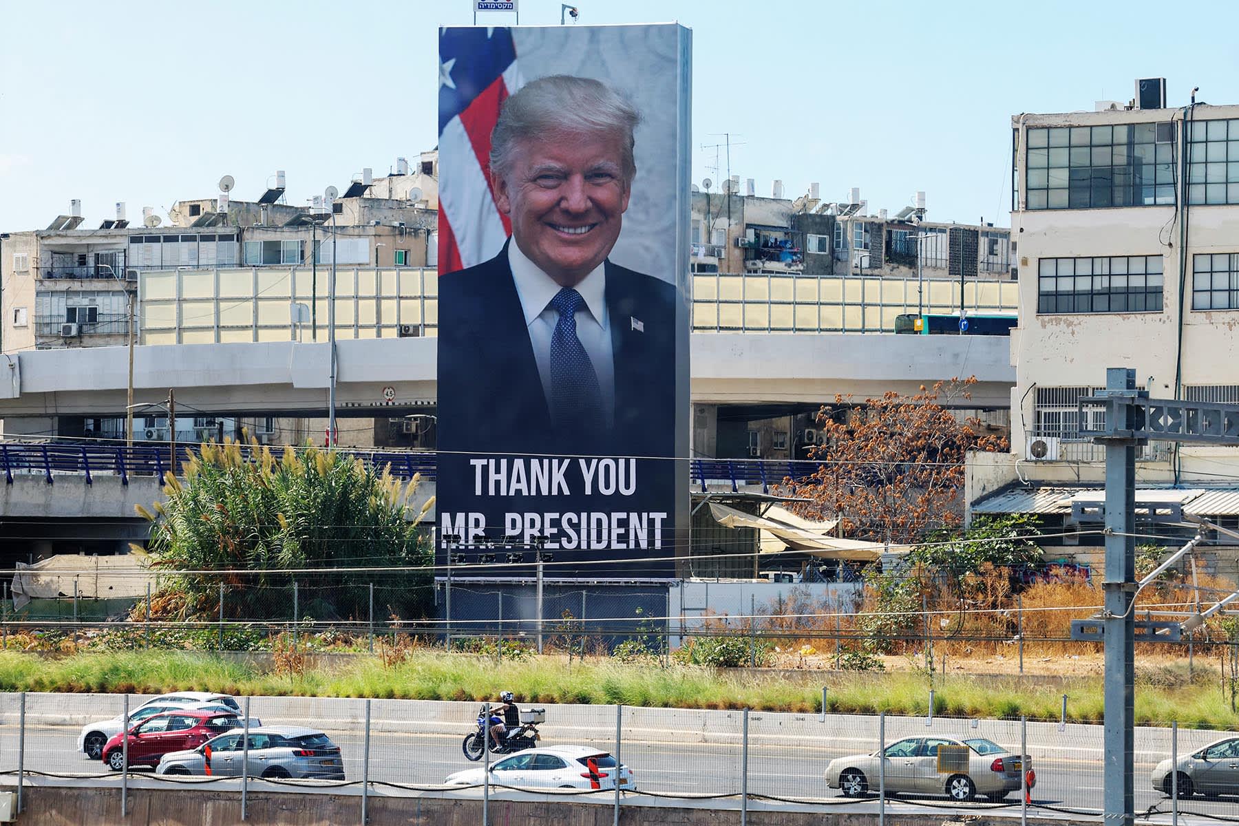 Motorists drive past a billboard thanking President Donald Trump in Tel Aviv on Oct. 10, 2025.