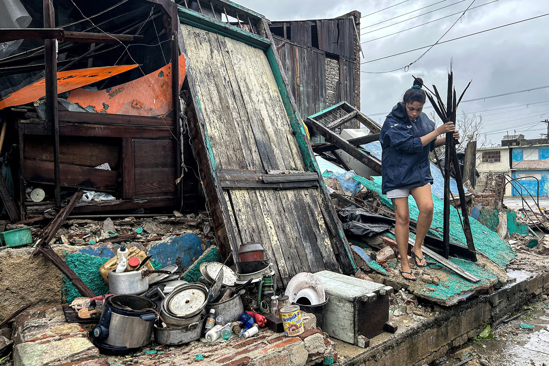 A woman salvages belongings from the rubble of her home after it collapsed during Hurricane Melissa's passage through Santiago de Cuba, Cuba, on Oct. 29, 2025.