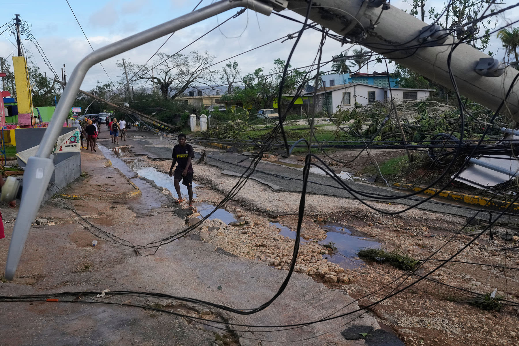 Residents walk through Santa Cruz, Jamaica, Wednesday, Oct. 29, 2025, after Hurricane Melissa passed.