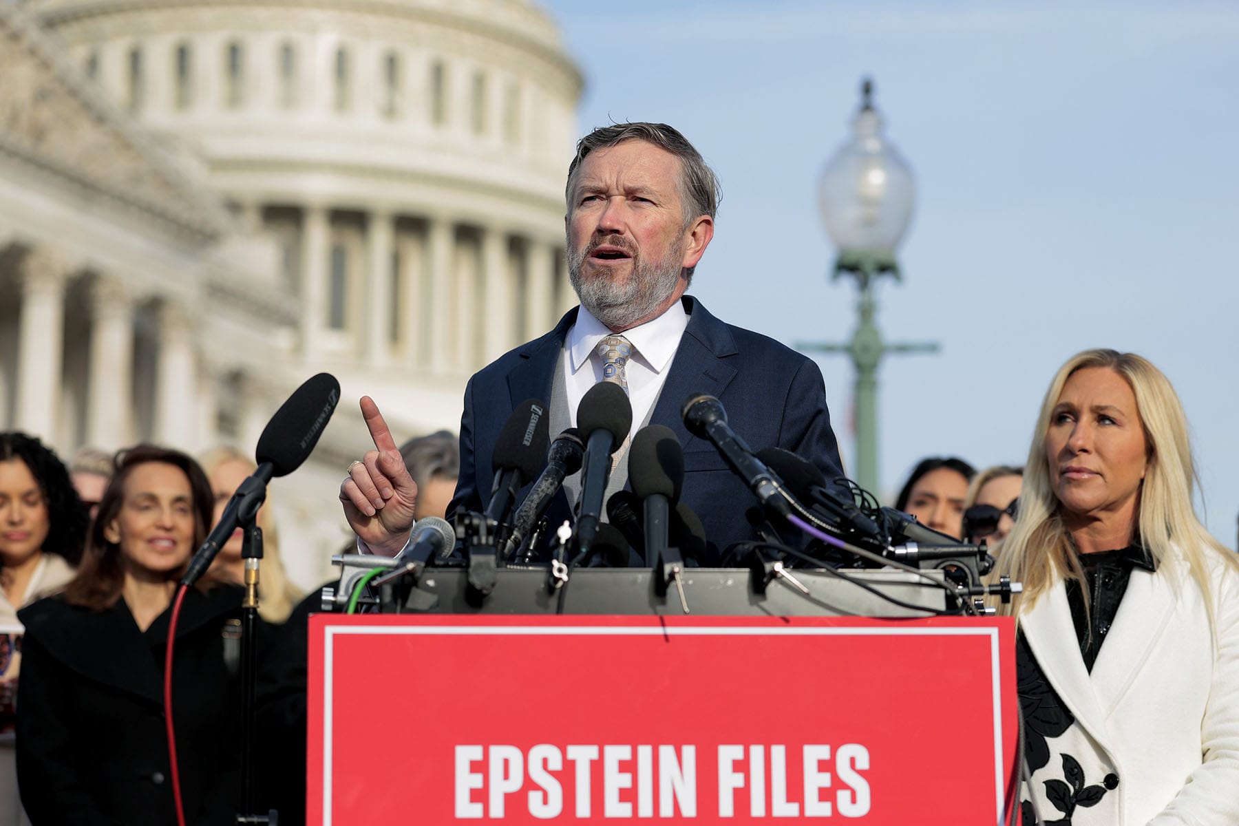 Rep. Thomas Massie, R-Ky., speaks as Rep. Marjorie Taylor Greene, R-Ga., looks on during a news conference with lawmakers on the Epstein Files Transparency Act outside the U.S. Capitol on November 18, 2025.