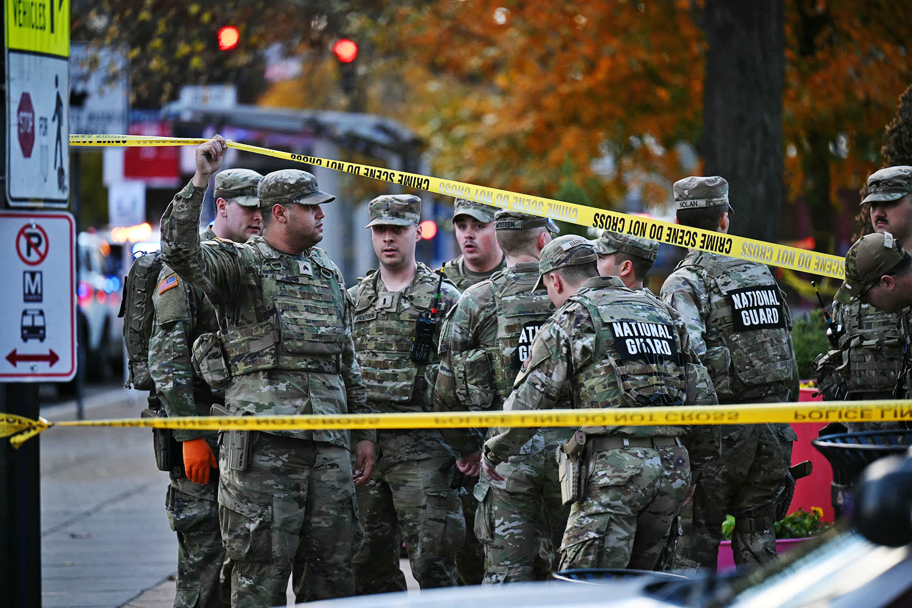 National Guard soldiers stand behind the crime scene tape at a corner in downtown Washington, D.C., on Nov. 26, 2025. 