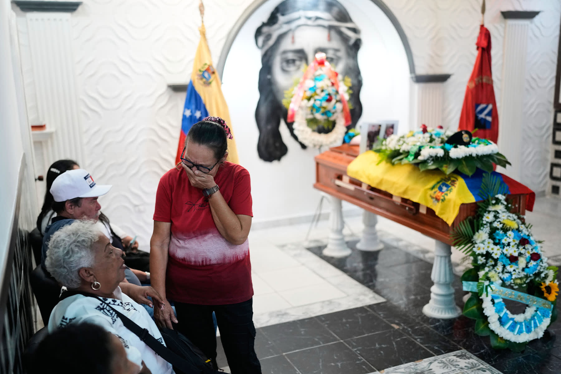 Ramona Palma, mother of Venezuelan soldier Cesar Garcia, mourns during his wake in Caracas on Wednesday, Jan. 7, 2026, after Garcia was killed in a U.S. raid that captured Venezuelan President Nicolas Maduro. 