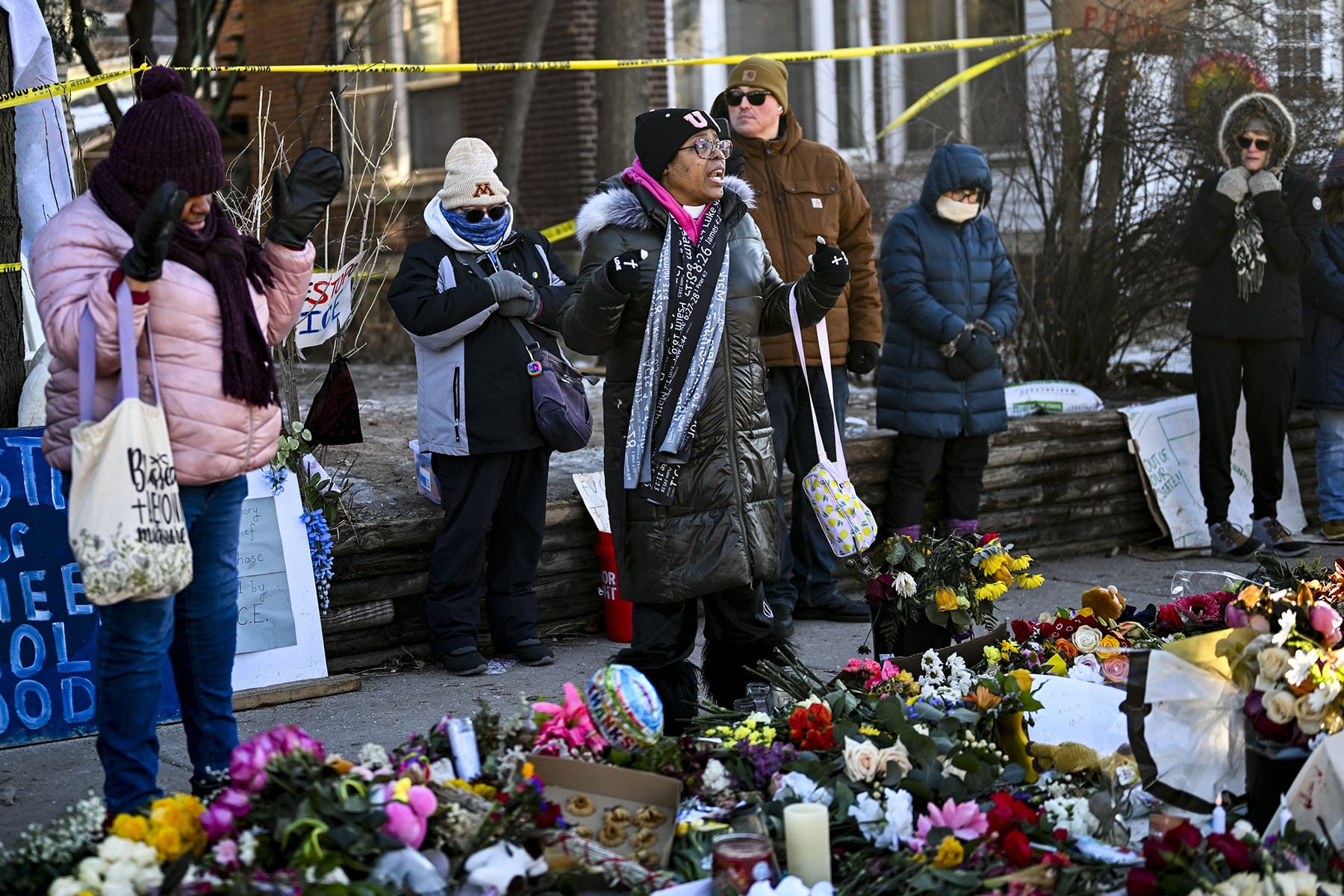 June Pierce prays during a vigil at a memorial on Jan. 14, 2026, near the site where Renee Good was killed in Minneapolis.