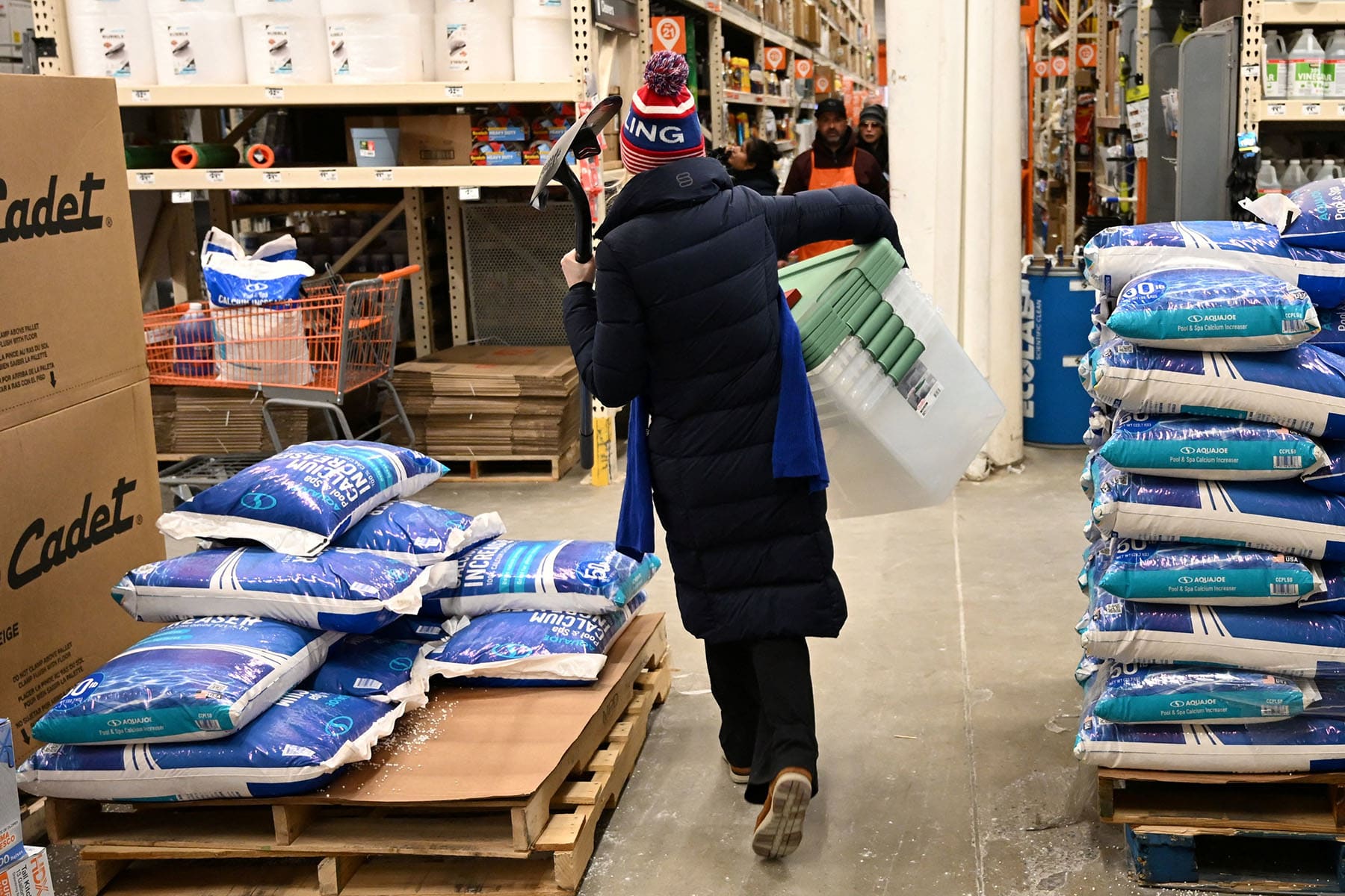 People shop for supplies at a Home Depot ahead of a massive winter storm in Falls Church, Virginia, on January 24, 2026. 