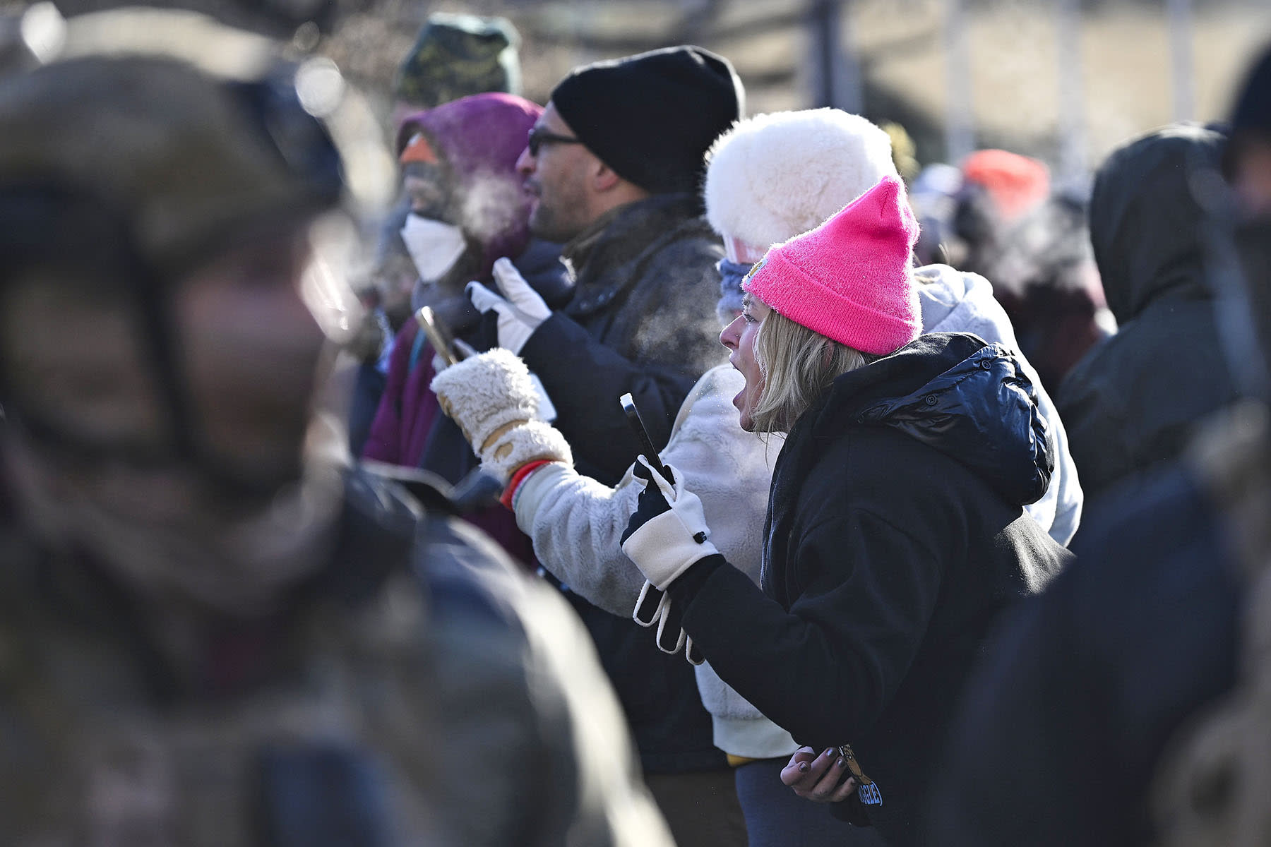 Protesters confront federal agents after a protestor was shot amid a scuffle to arrest him on January 24, 2026 in Minneapolis.