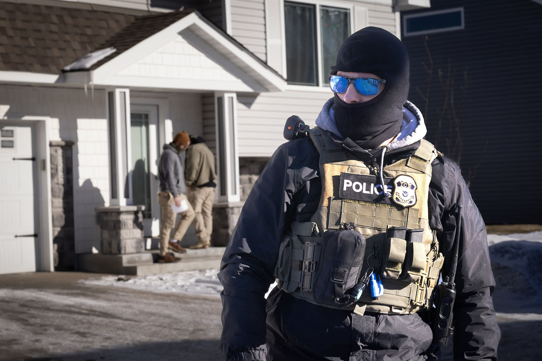 ICE agents look for someone at a home on Jan. 28, 2026 in Circle Pines, Minnesota.
