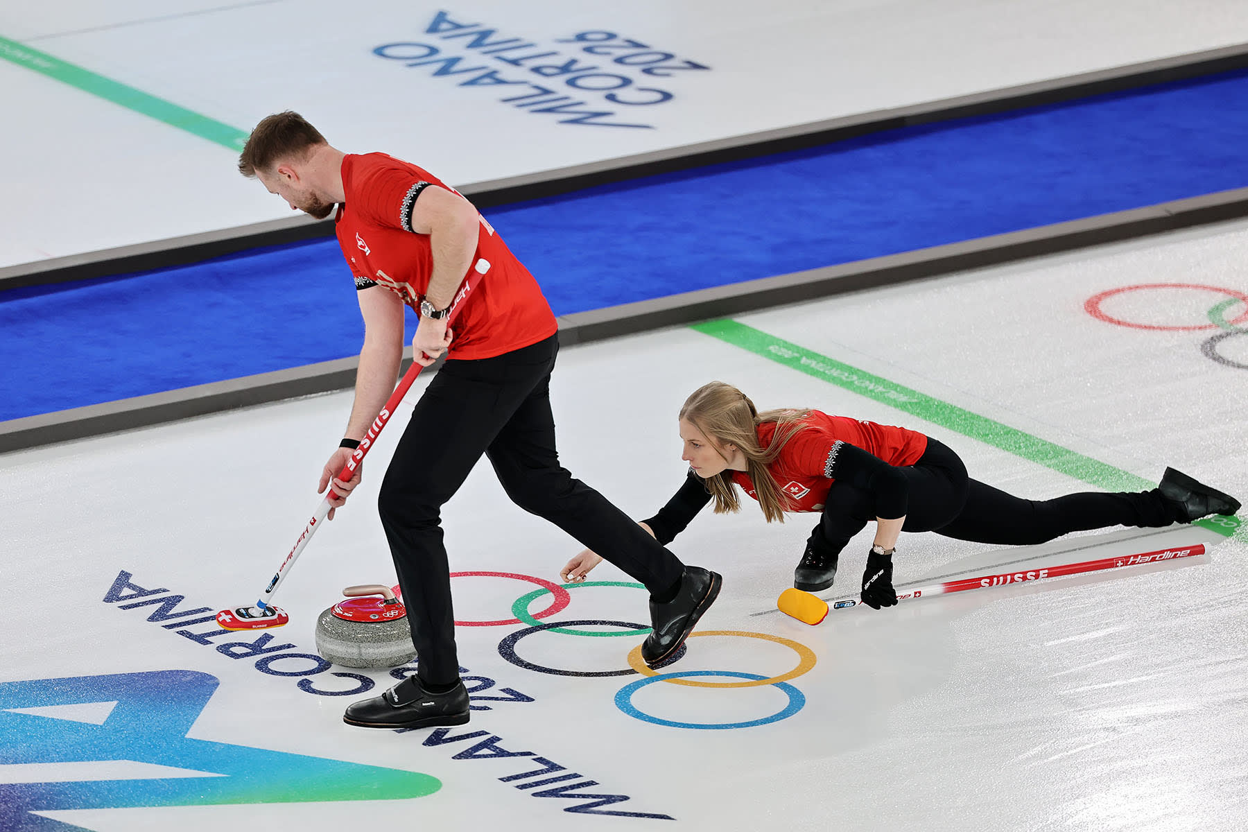 Yannick Schwaller and Briar Schwaller-Huerlimann of Team Switzerland practice curling