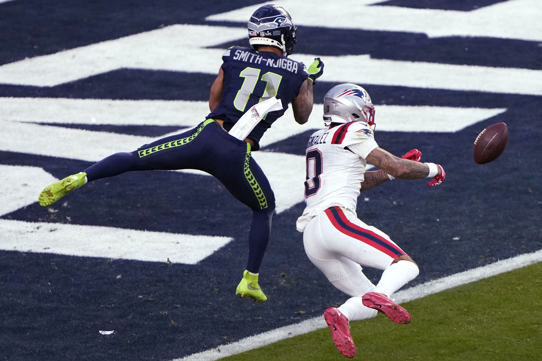 Christian Gonzalez of the New England Patriots breaks up a pass intended for Jaxon Smith-Njigba of the Seattle Seahawks.