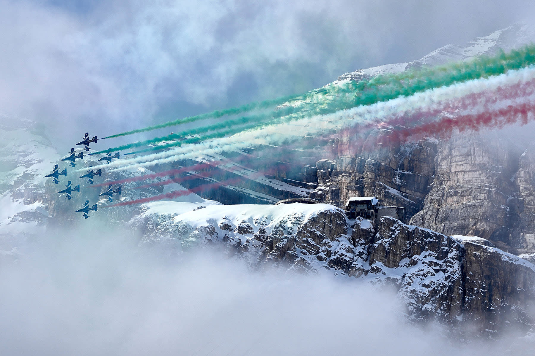 The Italian Aerobatic team, "Frecce Tricolori," fly over a deal ceremony at the 2026 Winter Olympics, in Cortina d'Ampezzo, Italy, Thursday, Feb. 12, 2026.