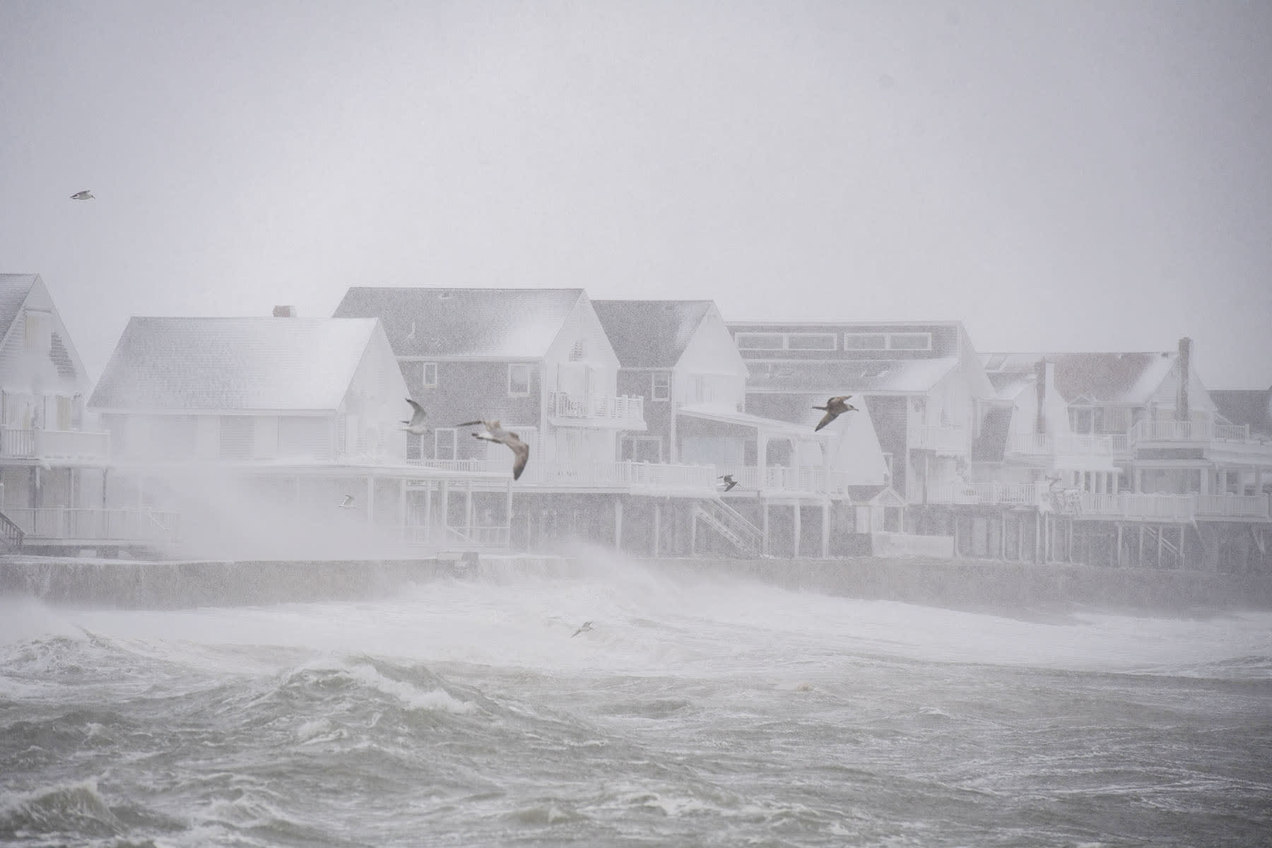 High waves pound houses on the shoreline in Scituate, Mass. on Feb. 23, 2026. 