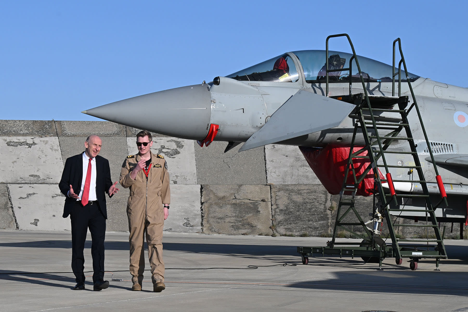 British Defense Minister John Healey meets the F-35 pilot who shot down a drone as they walk past British typhoon and F-35 jets at RAF Akrotiri on March 5, 2026 in Akrotiri, Cyprus. 