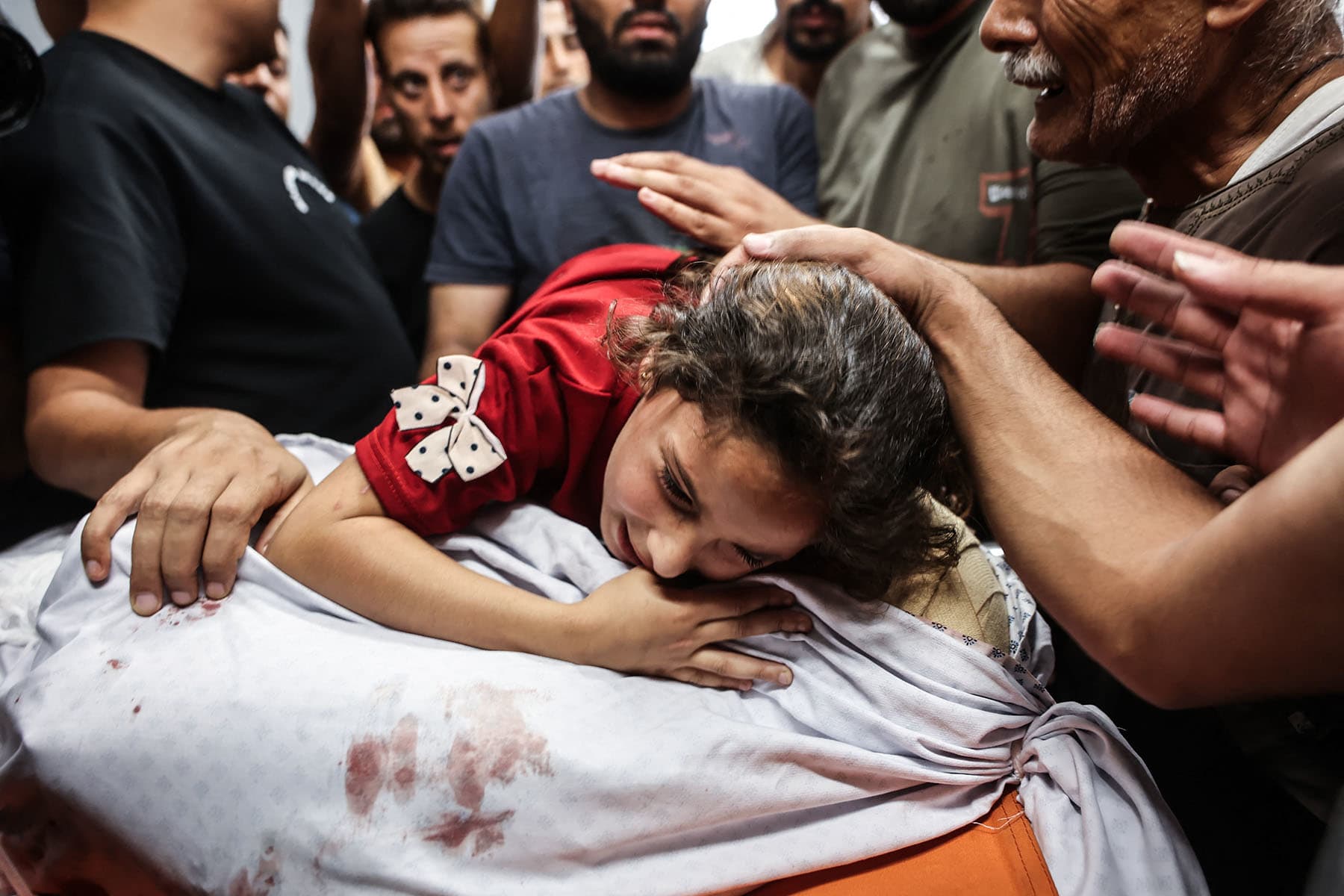 Zeina al-Habil hugs the body of her father after he and her 5-year-old brother were killed in an Israeli missile strike that targeted their home in Gaza City on June 15, 2026.
