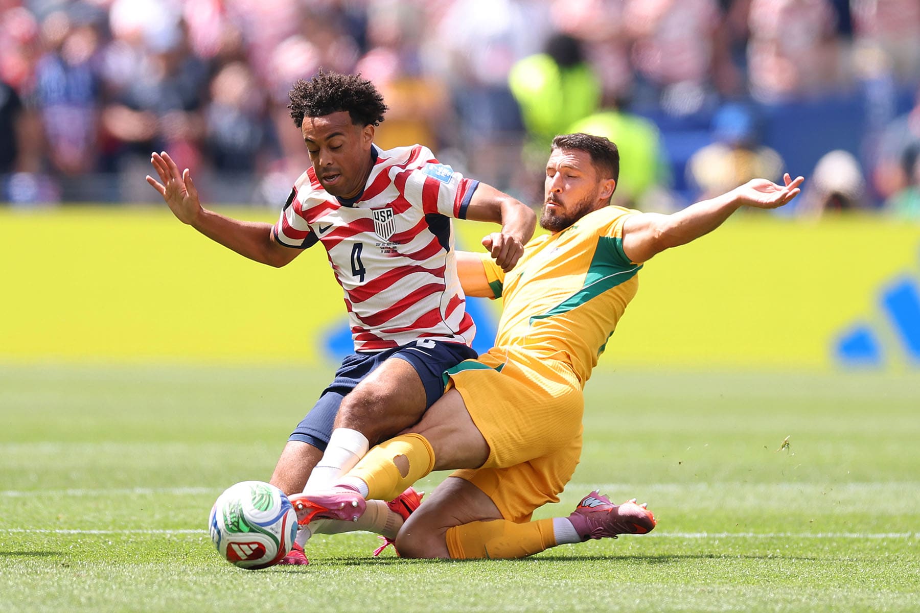 Tyler Adams of the U.S. is tackled by Mathew Leckie of Australia during a World Cup match on June 19, 2026 in Seattle.