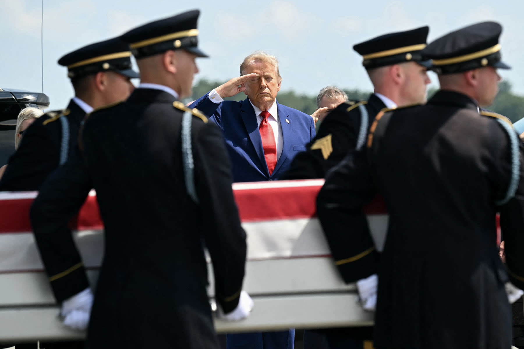 President Donald Trump salutes as a U.S. Army carry team carries the flag-draped transfer case containing the remains of 1st Lt. Tyler James Feehan, 25, of Ewa Beach, Hawaii, at Dover Air Force Base in Dover, Del., on July 22, 2026.