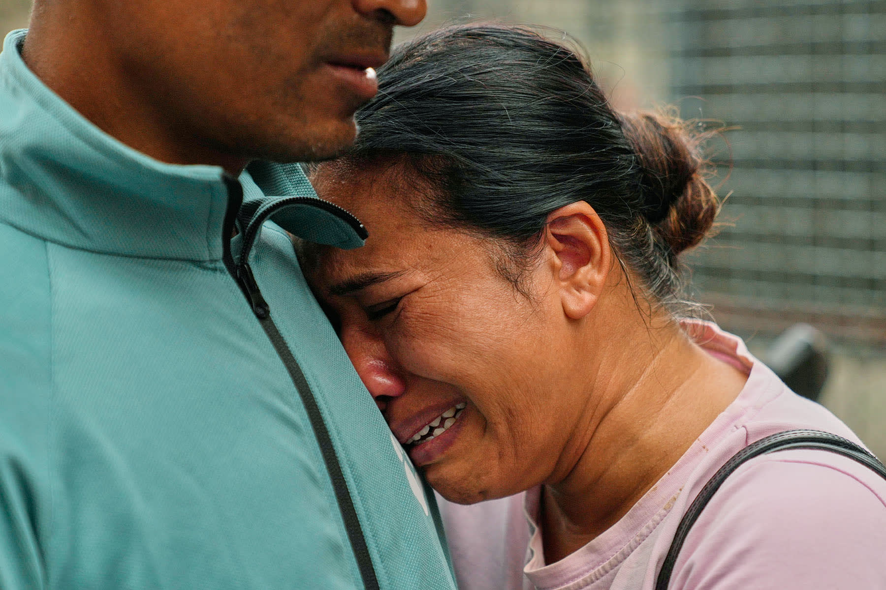 A relative consoles Sabina Dangal outside a government hospital as she waits for news of her brother, who is missing after flash floods, in Kathmandu, Nepal, Friday, Aug. 28, 2026. 