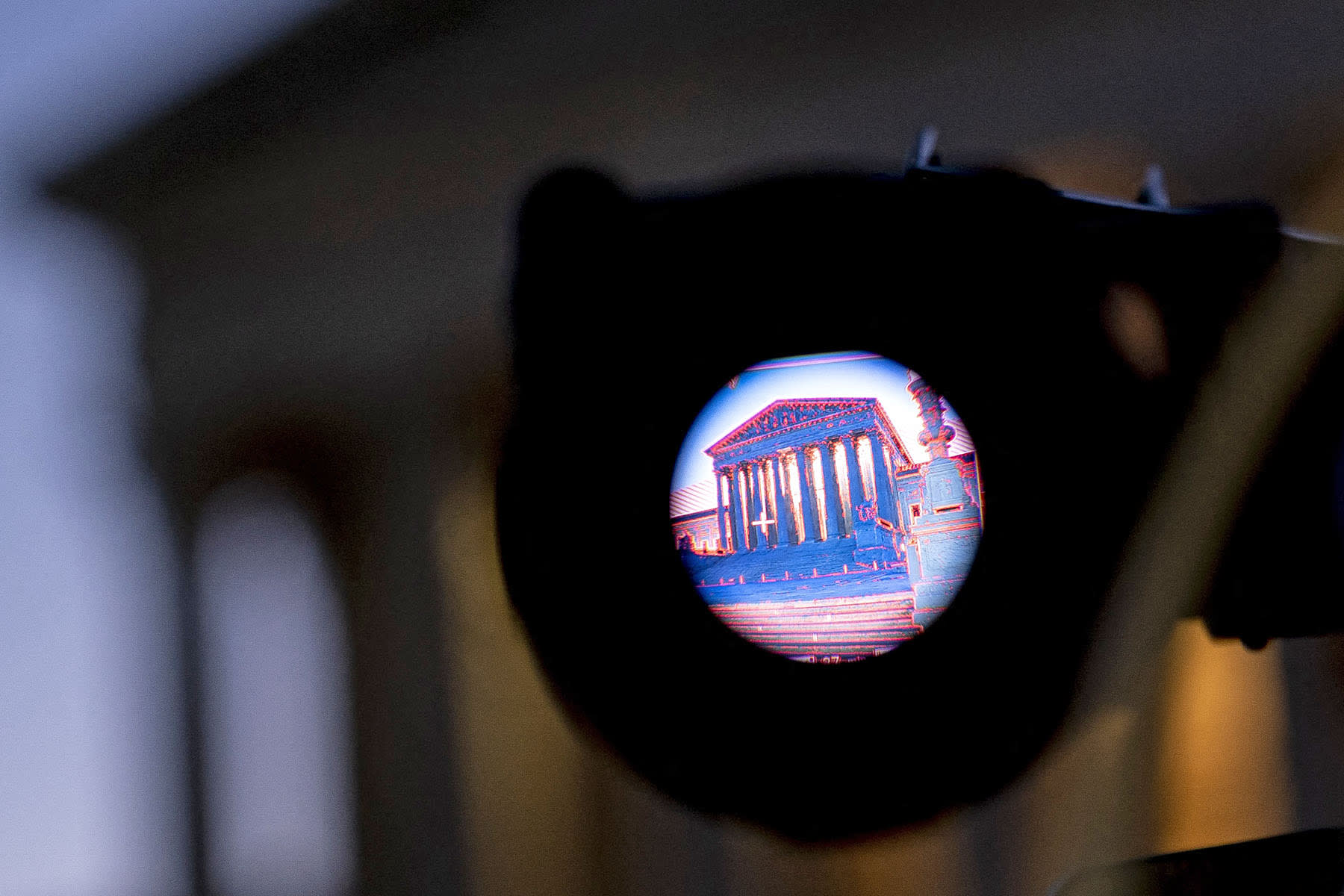 The Supreme Court is seen through the viewfinder of a television camera.