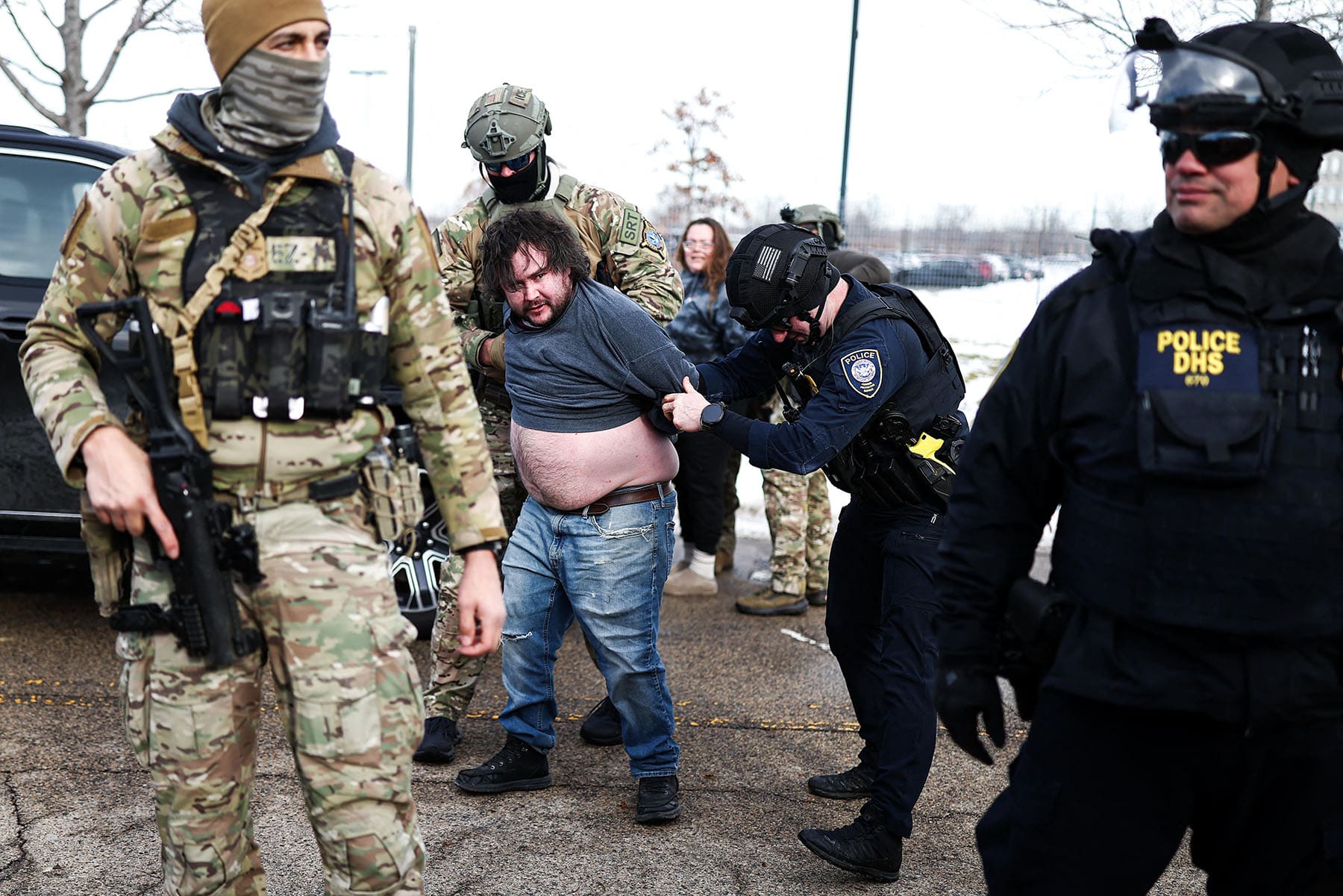 Federal agents detain a protester near the Bishop Henry Whipple Federal Building in Minneapolis, Minnesota, on January 9, 2026. 