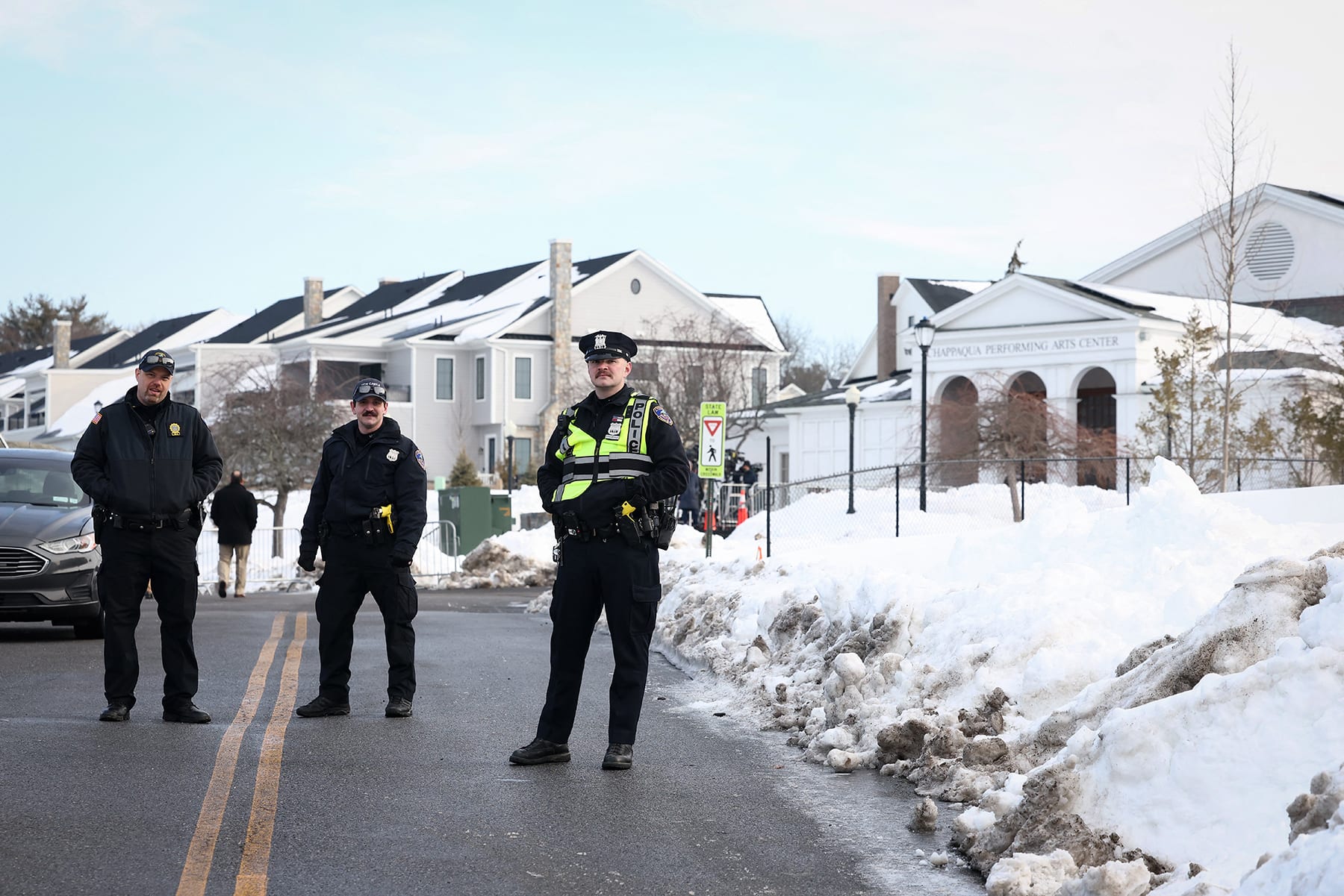 Police officers stand in the road near the Chappaqua Performing Arts Center in Chappaqua, N.Y. on February 26, 2026, ahead of the depositions of Hillary and Bill Clinton.