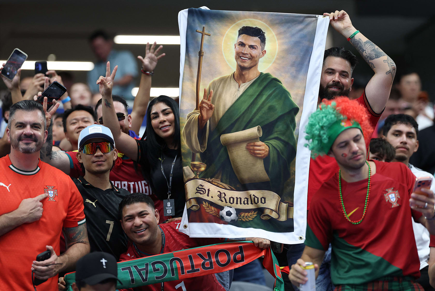 Portuguese fans show a sign depicting Portugal's forward Cristiano Ronaldo as a saint