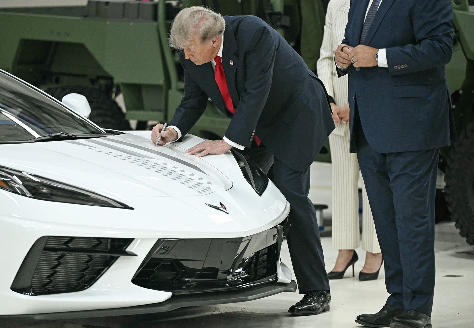 President Donald Trump signs a Corvette as he tours General Motors' Milford Proving Ground in Milford, Mich., on July 27, 2026. 
