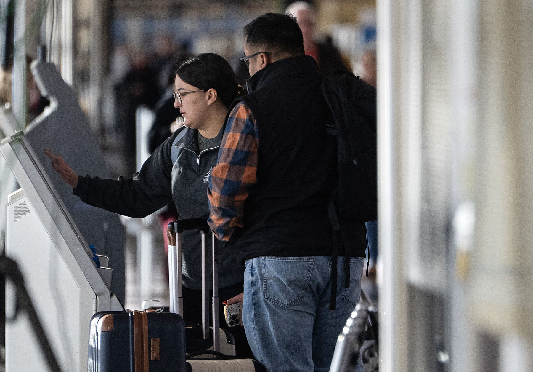 A woman checks in for an American Airlines flight at Ronald Reagan Washington National Airport in Arlington, Va., on Nov. 7, 2025.
