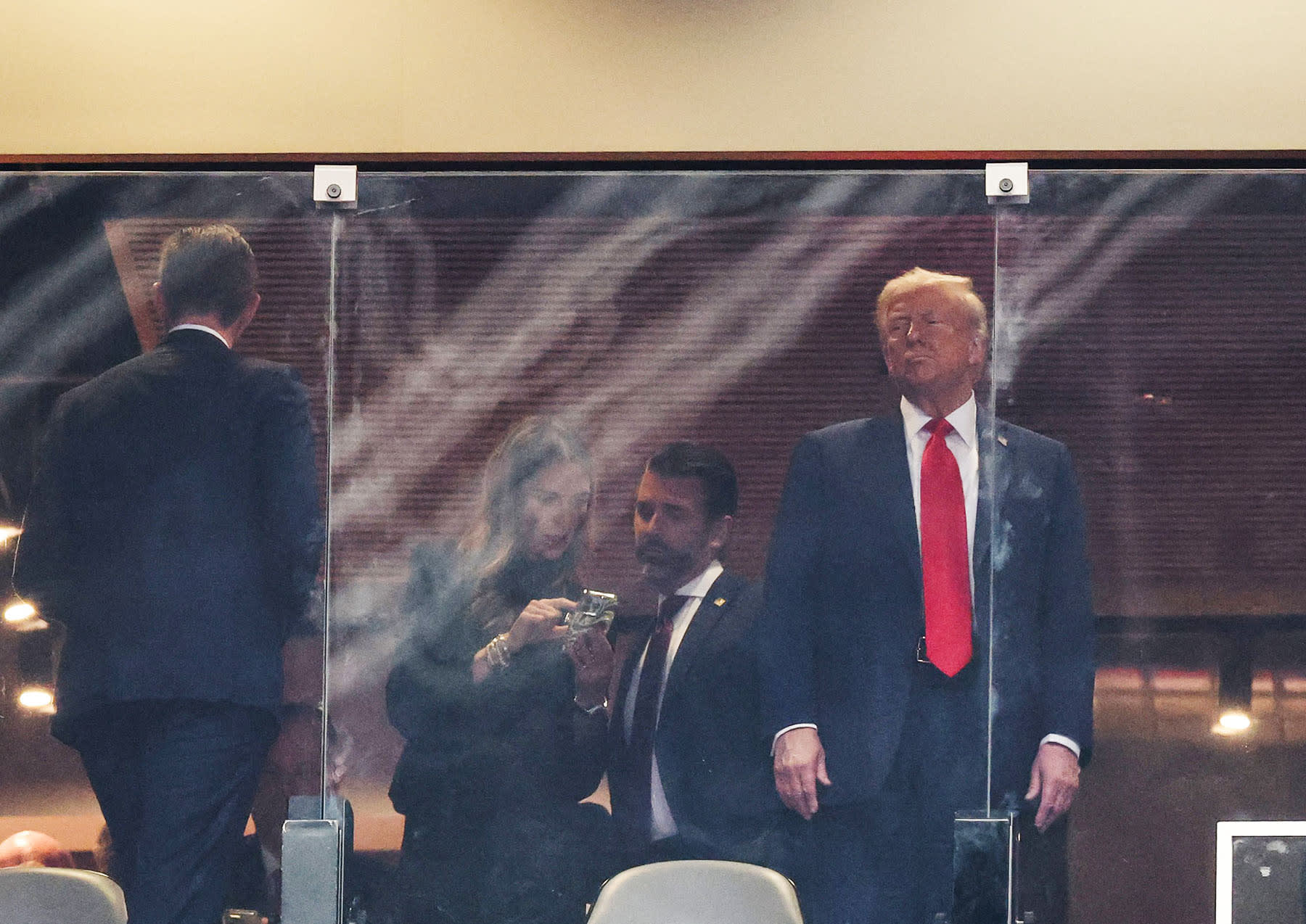 President Donald Trump, his son Eric Trump, Bettina Anderson and son Donald Trump Jr. attend the public memorial service for right-wing activist Charlie Kirk